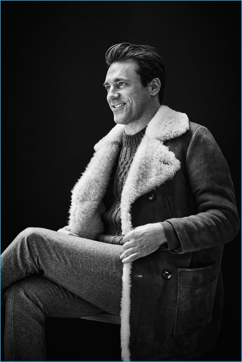Embracing the shearling trend, Jon Hamm wears a Saint Laurent double-breasted shearling coat, Maison Margiela cable-knit sweater, and Brunello Cucinelli slim-fit houndstooth wool trousers.