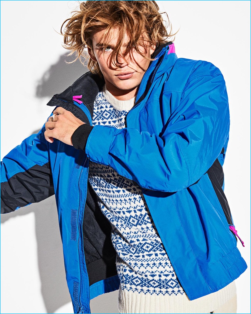 Tackling casual styles, Jordan Barrett wears a Penfield sweater with a blue Columbia jacket.