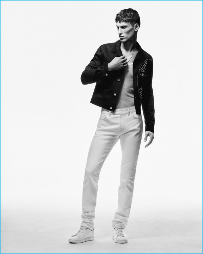 David Trulik dons white denim jeans from Louis Vuitton's exclusive collection.