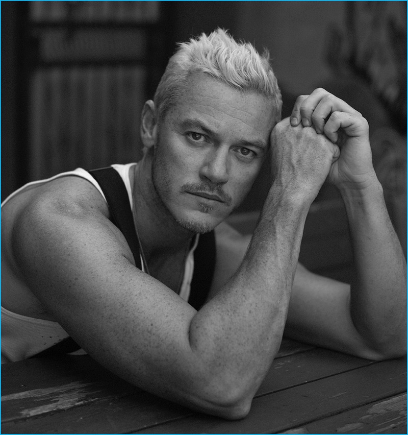 Luke Evans wears a vintage Calvin Klein tank with Giorgio Armani suspenders for Interview magazine.