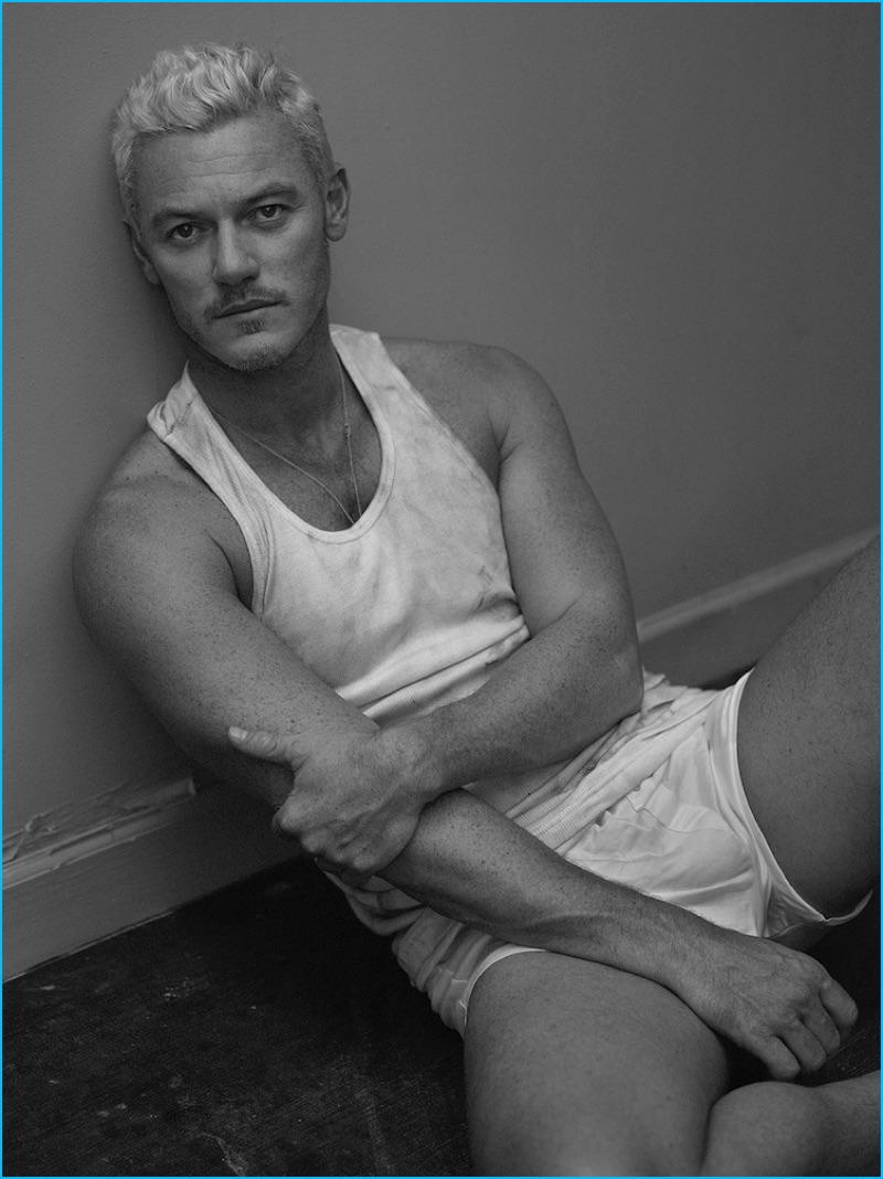 English actor Luke Evans stars in an Interview photo shoot, wearing a vintage Calvin Klein tank with Hanro underwear.