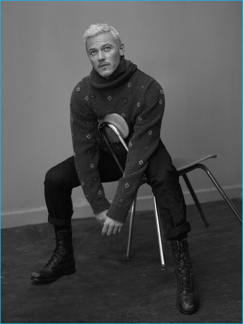 Sitting for a black & white portrait, Luke Evans dons an Ermenegildo Zegna Couture sweater and pants with vintage leather boots for Interview.