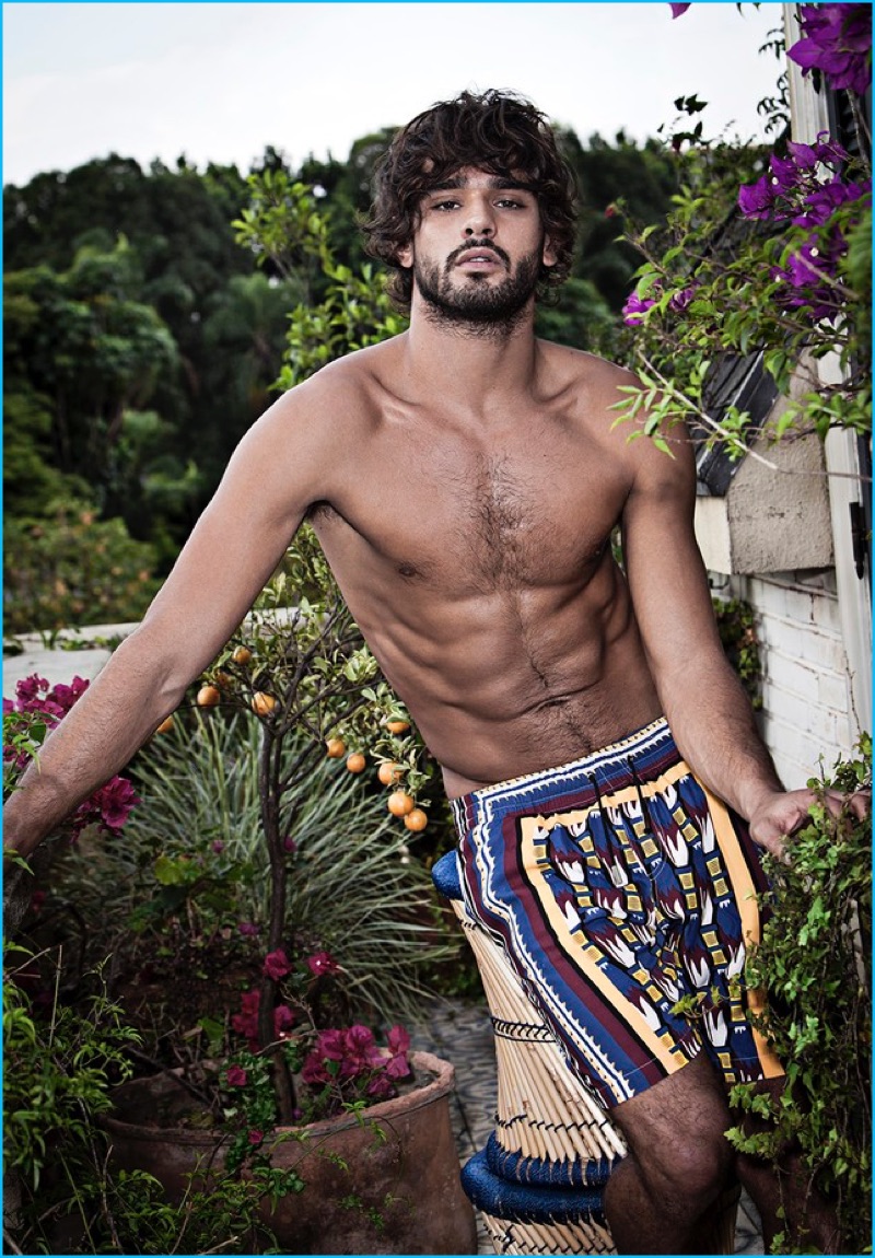 Going shirtless, Marlon Teixeira models graphic swim shorts for Murilo Lomas' spring-summer 2017 campaign.