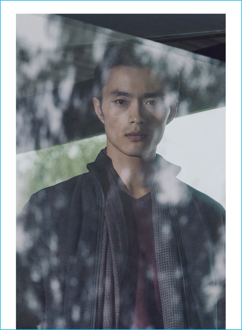 Zhao Lei pictured in a quilted cardigan, v-neck sweater, and reversible textured wool scarf from Massimo Dutti.
