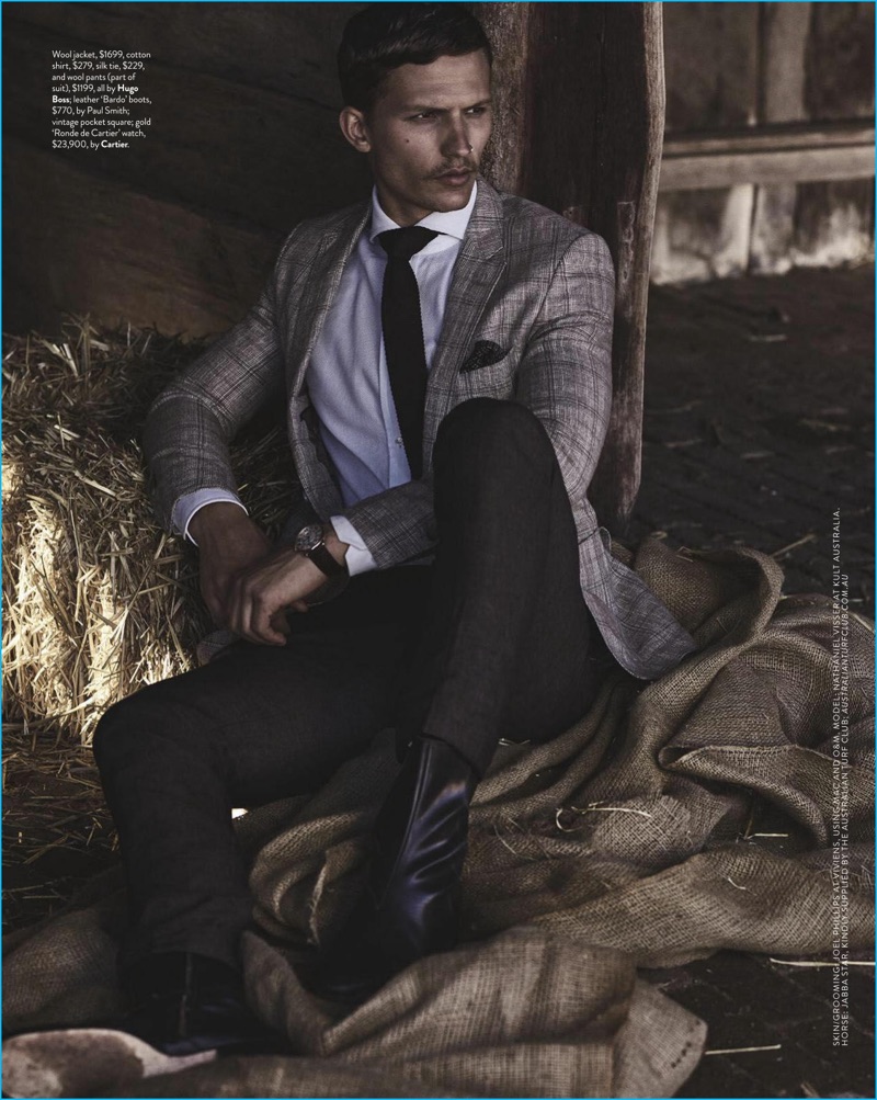 Appearing in an editorial for GQ Australia, Nathaniel Visser sports a Hugo Boss tailored look with Paul Smith leather boots, and a Cartier watch.