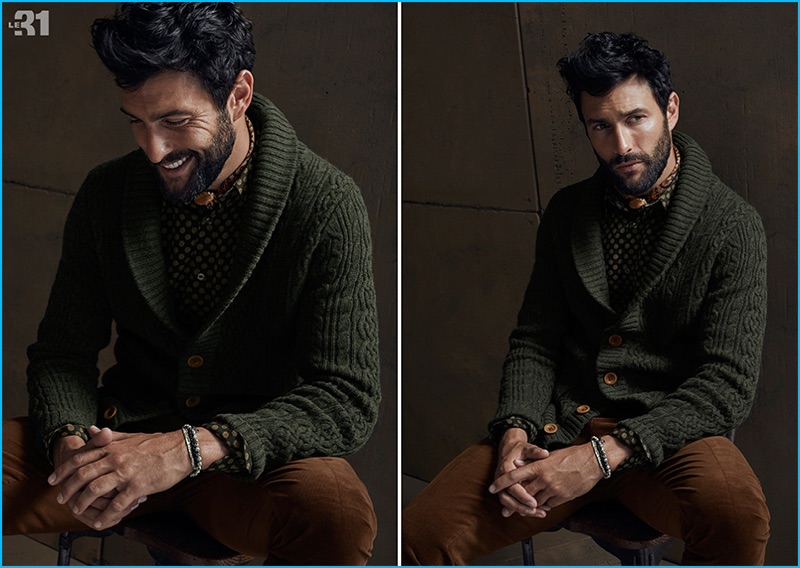 American model Noah Mills dons a green shawl neck cardigan sweater with a patterned shirt from Simons.