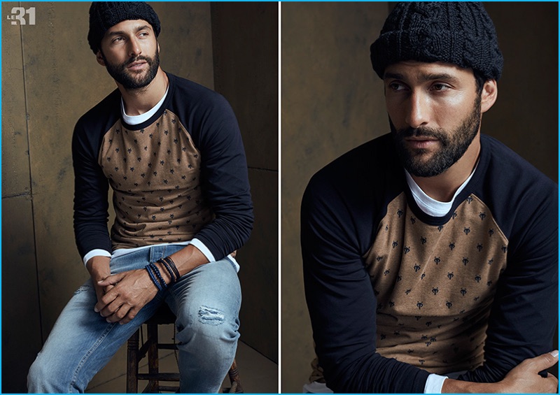 Model Noah Mills charms in a LE 31 raglan t-shirt with a Highland knit beanie and Levi's denim jeans.