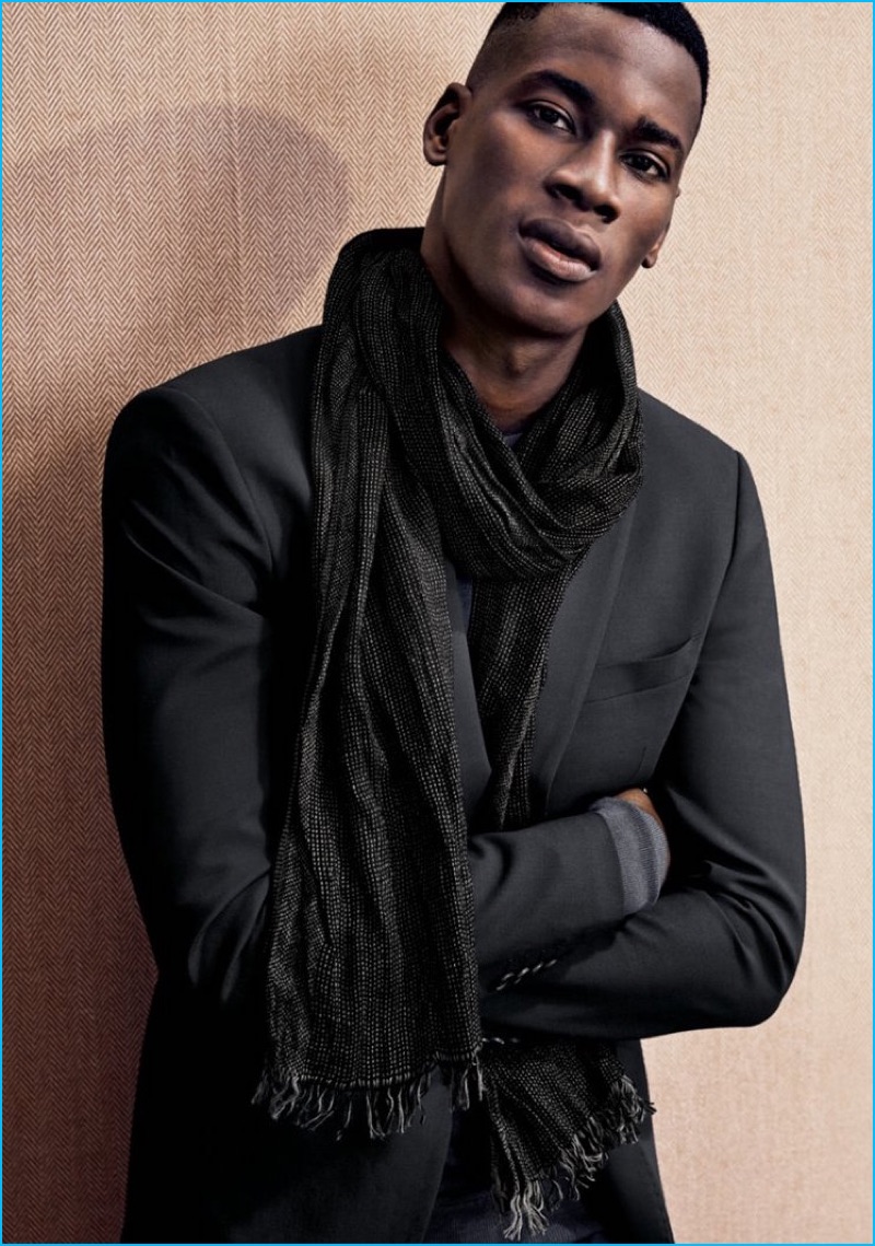 David Agbodji embraces a stylish cool in a Theory blazer, worn with a John Varvatos Star USA scarf.