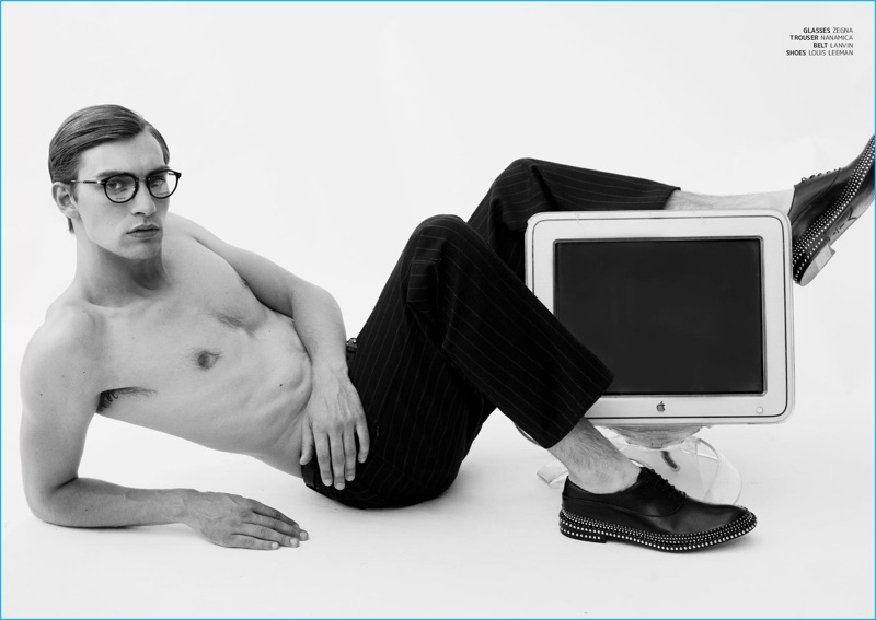 Going shirtless for JÓN magazine, George Le Page poses in Zegna glasses with Nanamica pinstripe trousers and studded Louis Leeman shoes.