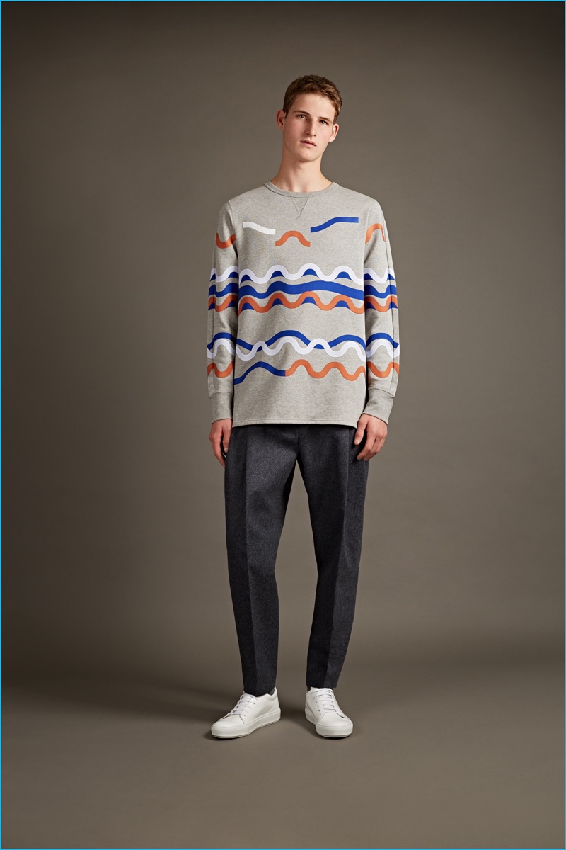 Acne Studios fun print sweatshirt, pleated trousers, and white sneakers.