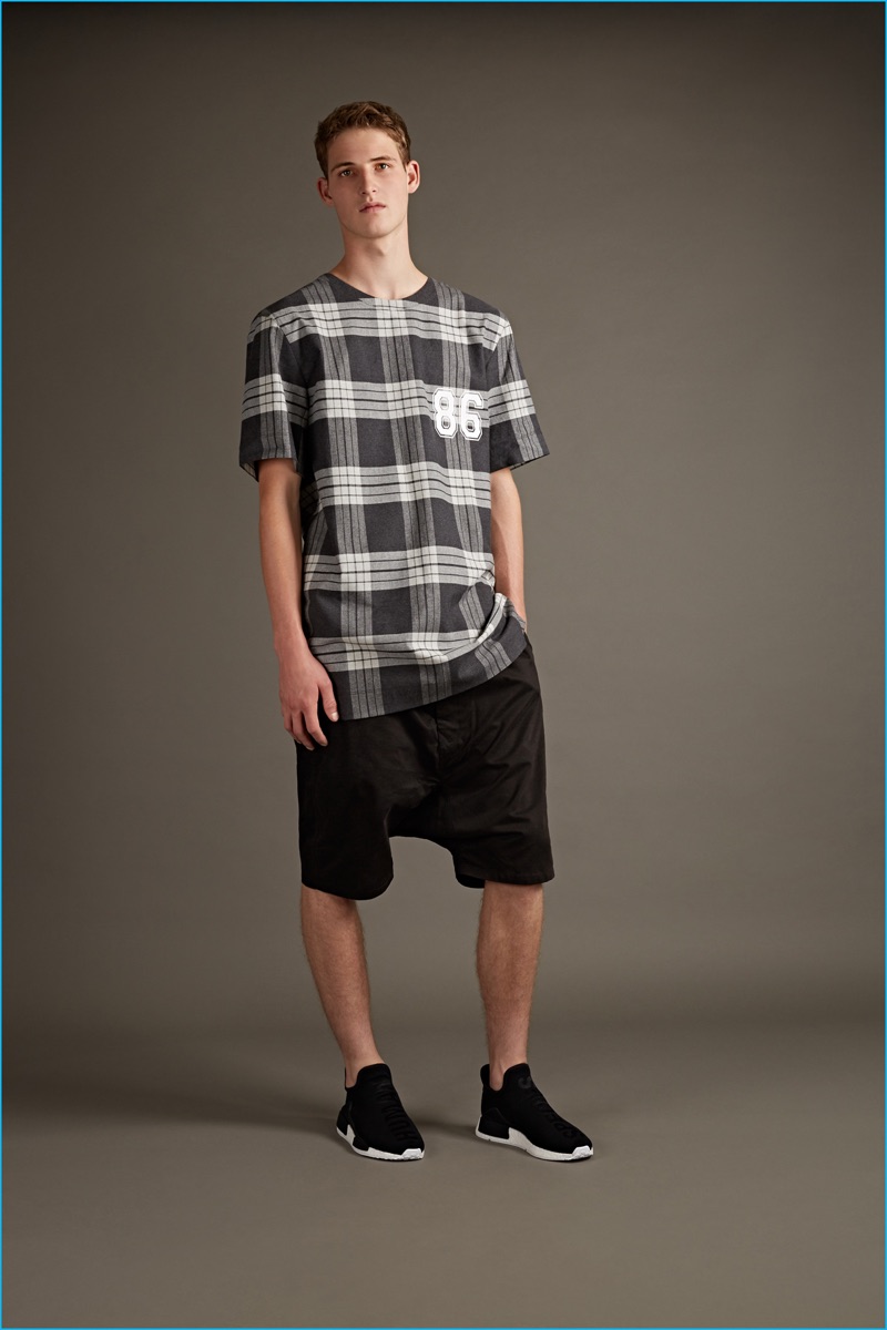 Helmut Lang oversized plaid t-shirt and black side stripe neoprene shorts with Y-3 high sneakers.