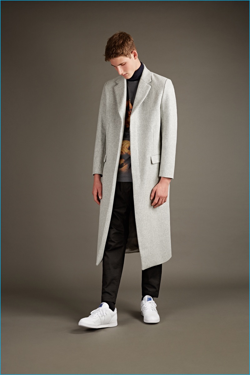 Matthew Miller pale grey wool overcoat, Head of Goliath Carvaggio t-shirt, and black wool trousers with Nike sneakers.
