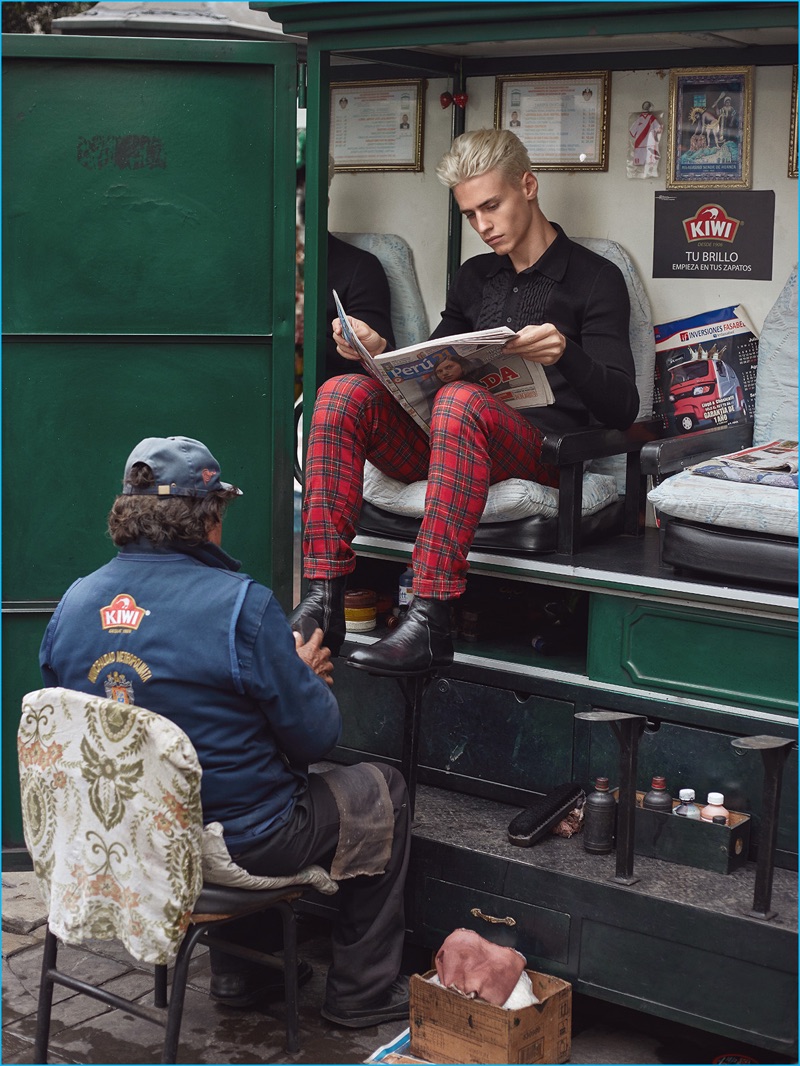 Getting his Calvin Klein boots shined, Oliver Stummvoll wears a Bottega Veneta shirt with Department 5 tartan trousers.