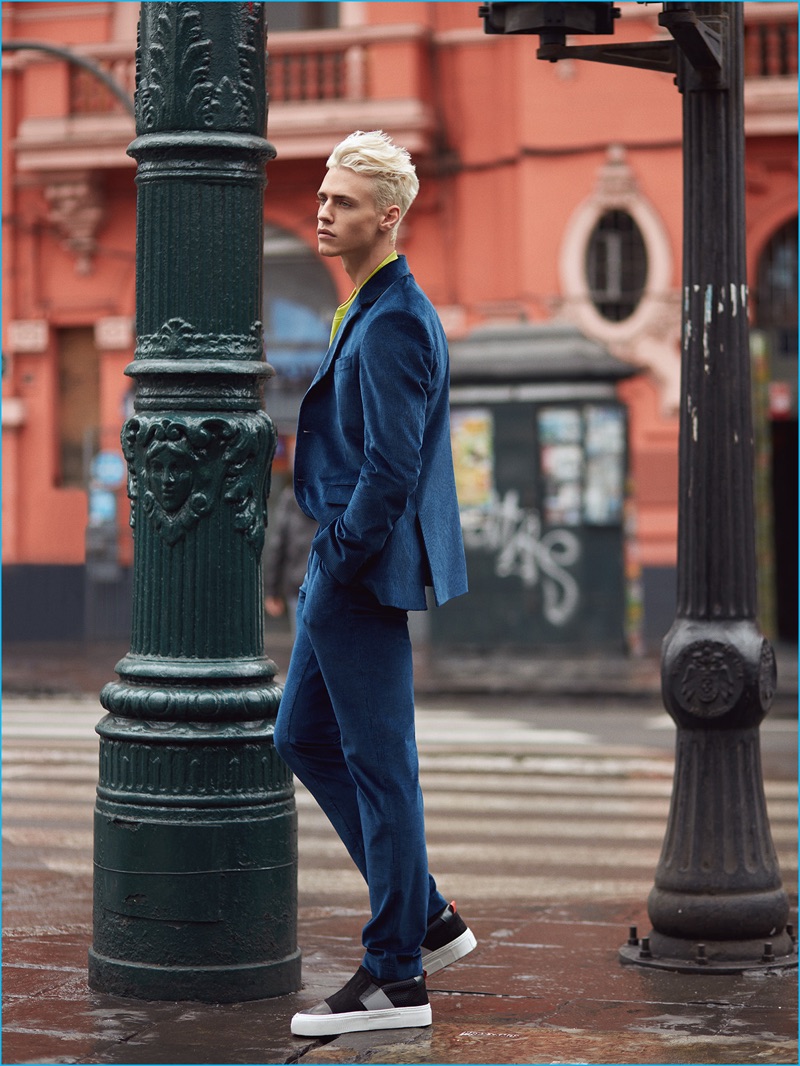 Stepping out, Oliver Stummvoll dons a colorful sweater and velvet suit from Hugo Boss with sneakers by Salvatore Ferragamo.