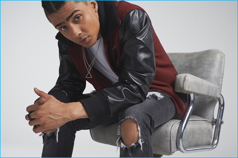 Quincy pictured in a bomber jacket and ripped denim jeans from BoohooMan's fall-winter 2016 capsule collection.