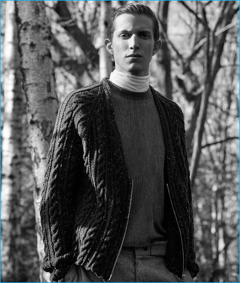 Xavier Buestel wears a wool zippered cardigan, cotton-blend jersey sweatshirt, and track pants from Raey with a Jil Sander turtleneck sweater.