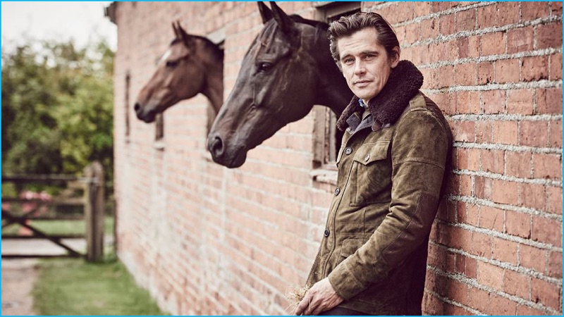Werner Schreyer wears a shearling and leather-trimmed suede field jacket, cashmere sweater, and chambray shirt from Ralph Lauren Purple Label.