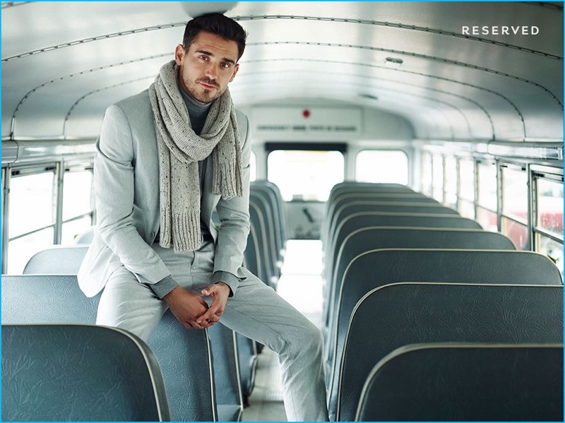 Posing on a bus for Reserved's fall-winter 2016 campaign, Arthur Kulkov models a pale grey suit.