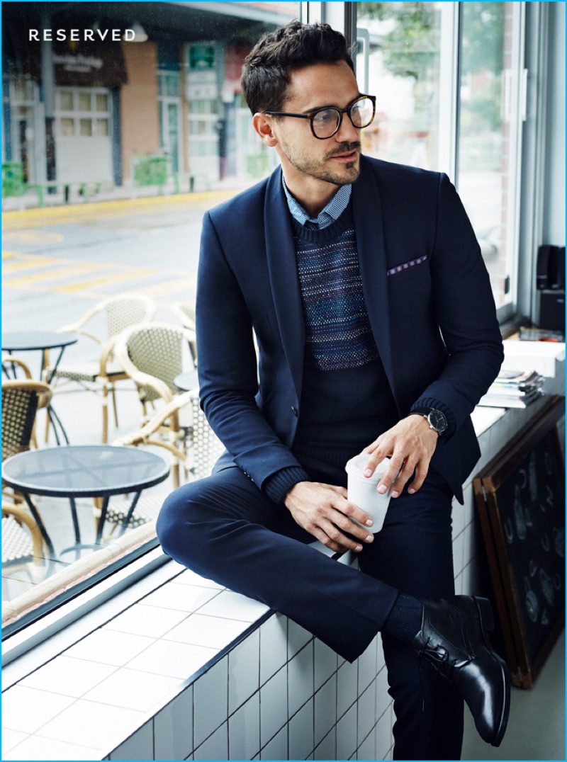 Embracing a smart ensemble, Arthur Kulkov dons glasses for Reserved's fall-winter 2016 campaign.