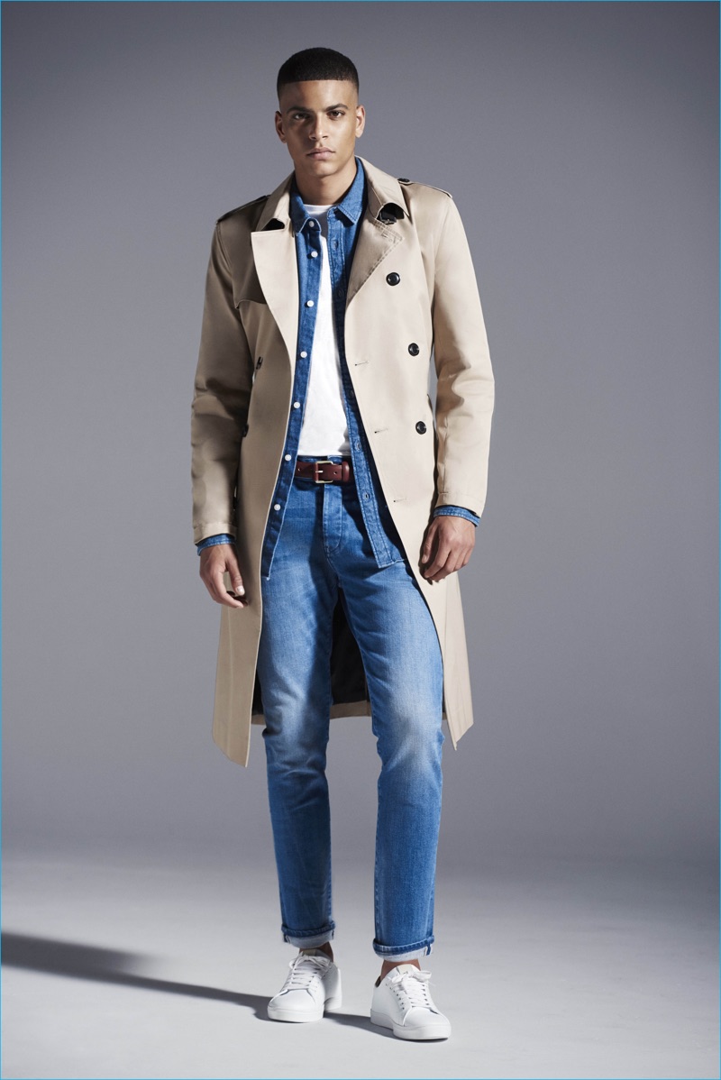 Zakaria Khiare doubles down on denim, completing his look with a River Island trench coat.