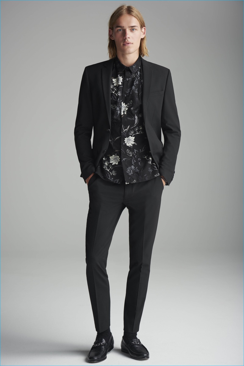 Ton Heukels dons a black suit with a floral print shirt from River Island.