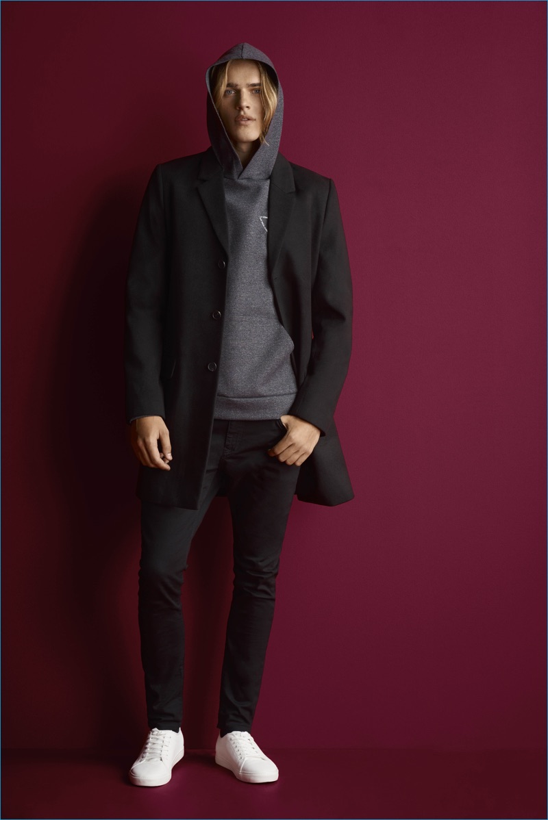 River Island goes sporty with a tailored coat and hooded sweatshirt, paired with skinny jeans.