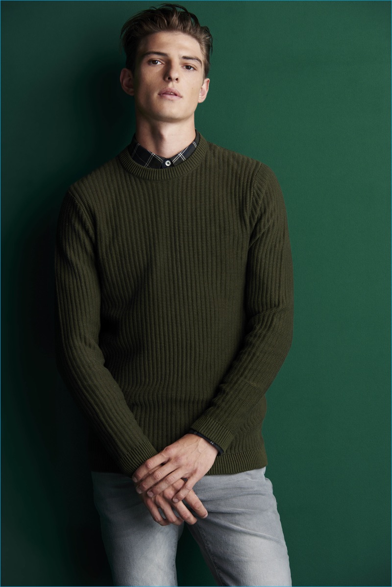 Playing it smart, Guerrino Santulliana wears a green sweater with a fitted button-down shirt from River Island.