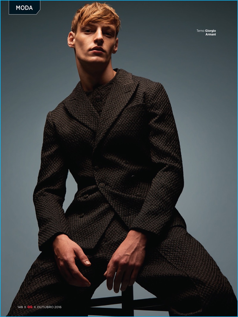 Wearing designer suiting, Roberto Sipos models a double-breasted look from Giorgio Armani for GQ Brasil.
