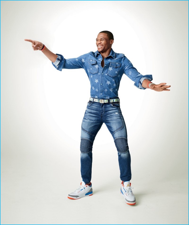 Doubling down on denim, Russell Westbrook wears a star adorned denim shirt from Valentino with True Religion jeans, a Gucci belt, and Jordan Brand sneakers for GQ.