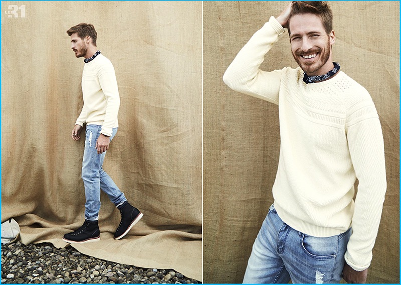 All smiles, Ryan Burns rocks a jacquard sweater, ultra-faded distressed denim jeans, and a paisley bandana from LE 31.