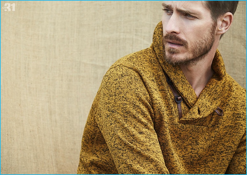 Warming up to dark yellow, Ryan Burns wears a marled nautical sweatshirt from LE 31.