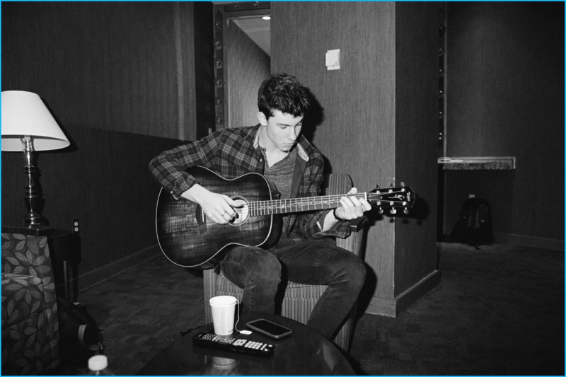 Singer Shawn Mendes plays on his guitar for HERO magazine.