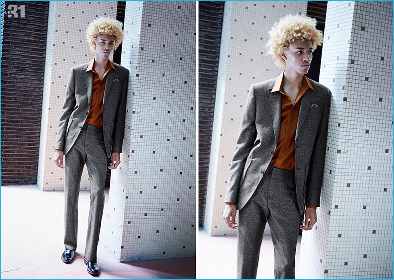 Starring in Simons' fall lookbook, Michael Lockley wears a copper hued stretch shirt with a 70s inspired longline jacket and flared trousers from LE 31.