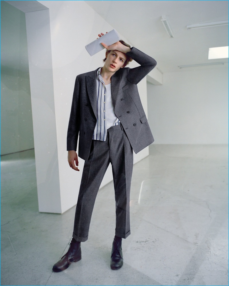Model Finnlay Davis dons a double-breasted Brunello Cucinelli suit with a vintage tank and shirt with John Alexander Skelton leather boots.