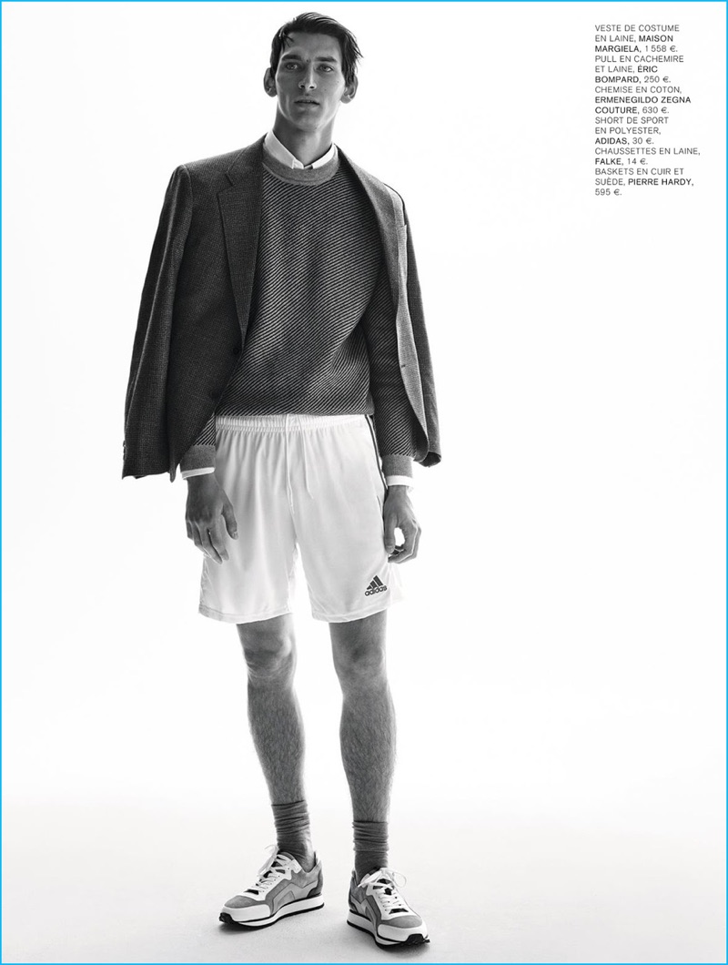 Thibaud Charon models a collision of styles with a Maison Margiela blazer, Eric Bompard sweater, Ermenegildo Zegna Couture shirt, Adidas shorts, and Pierre Hardy sneakers.