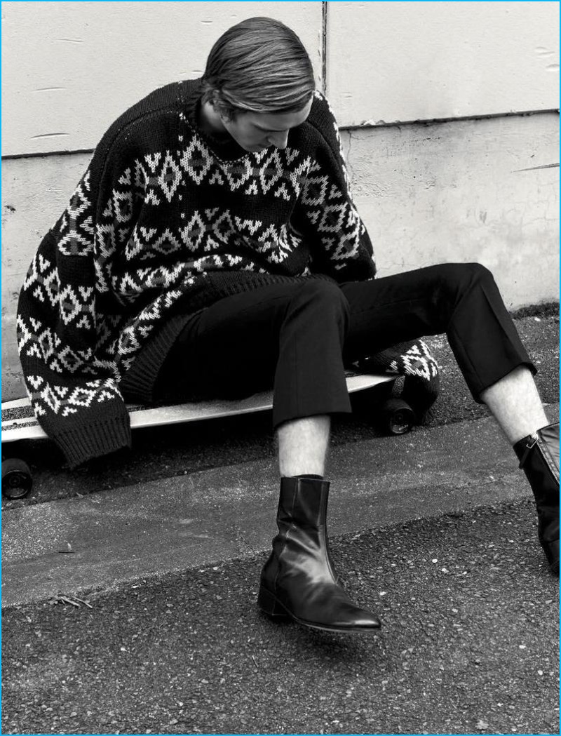 Tim Dibble dons an oversized sweater and cropped trousers from Raf Simons with Paul Smith leather boots for L'Officiel Hommes Germany.