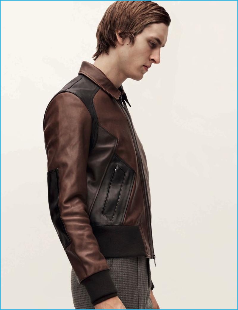 Tim Dibble sports a brown and black leather jacket from Neil Barrett for L'Officiel Hommes Germany.