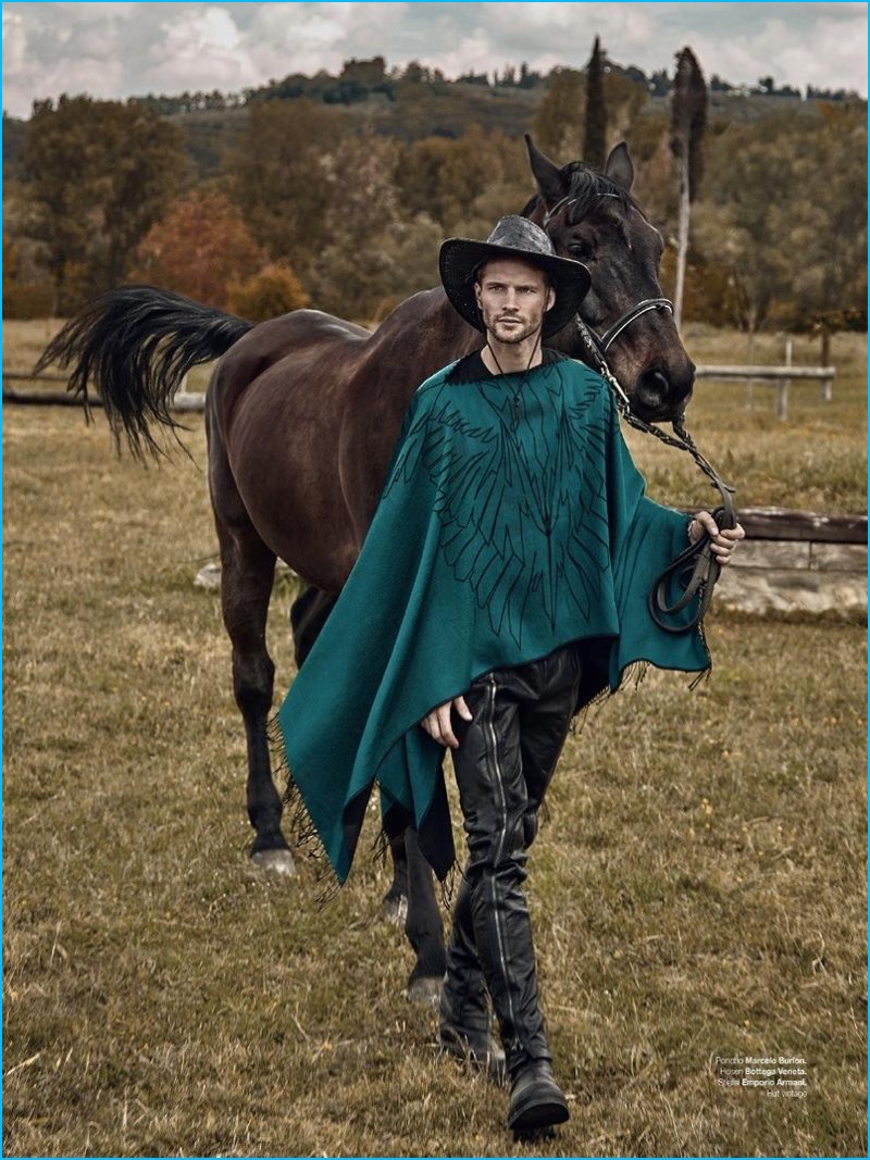 Tomas Skoloudik dons a Marcelo Burlon cape with leather Bottega Veneta pants, and an Emporio Armani sweater.