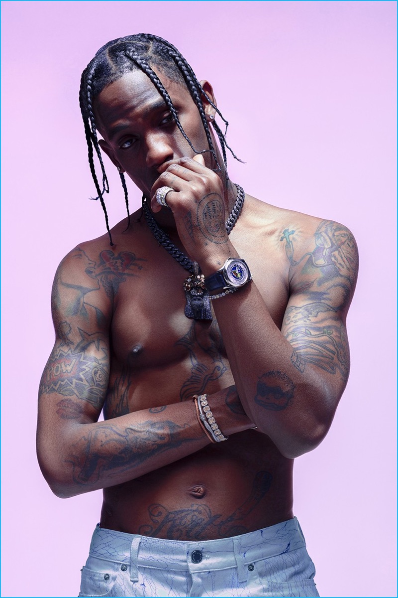 Going shirtless for Paper magazine, Travis Scott rocks Louis Vuitton denim jeans.