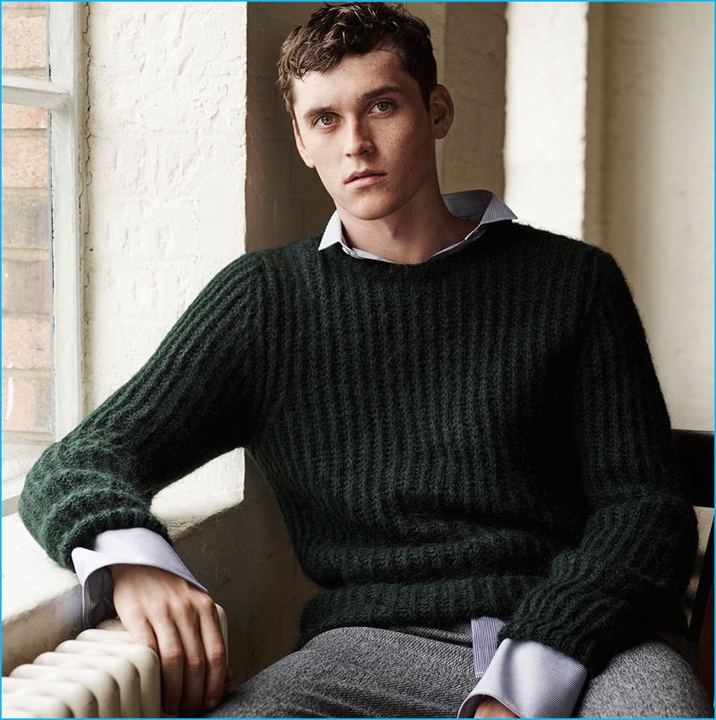 Anders Hayward wears a hunter green sweater with darted trousers from Zara Man.