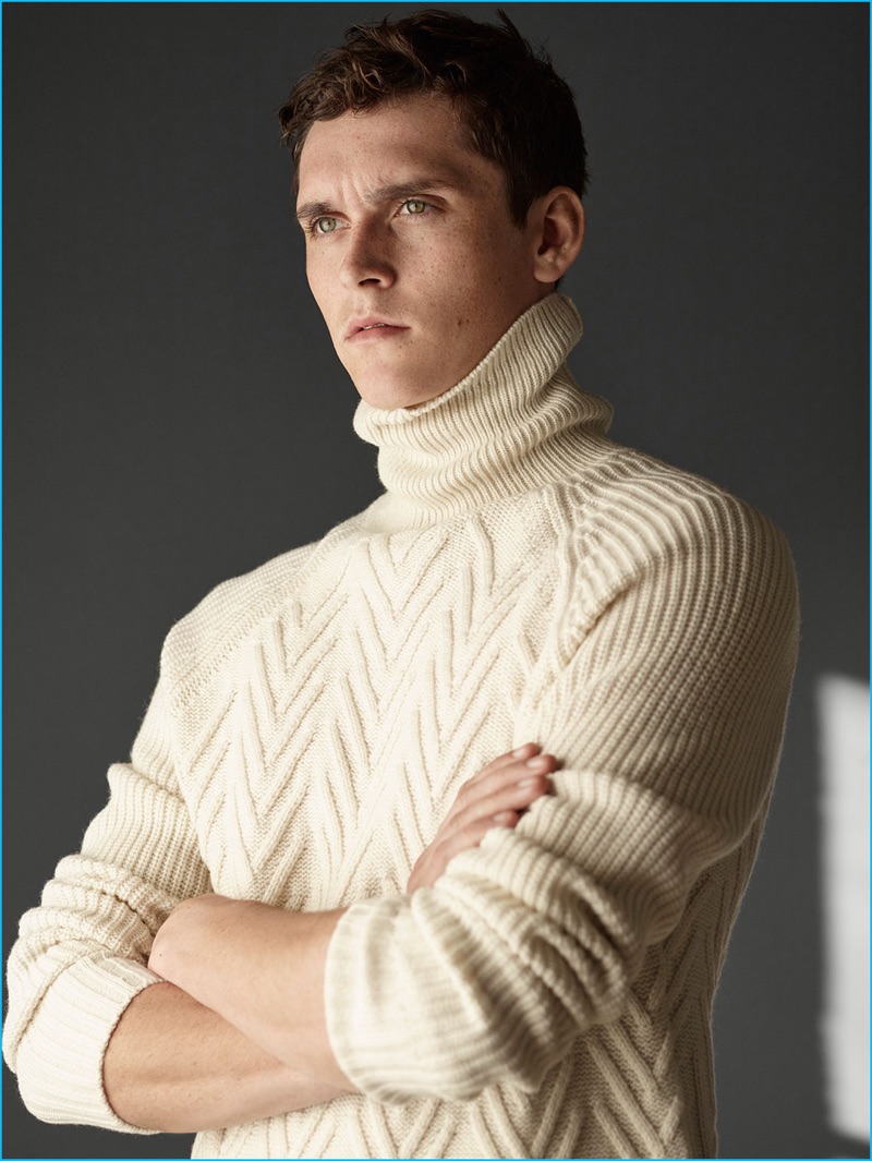 English model Anders Hayward dons a cream turtleneck sweater from Zara Man.