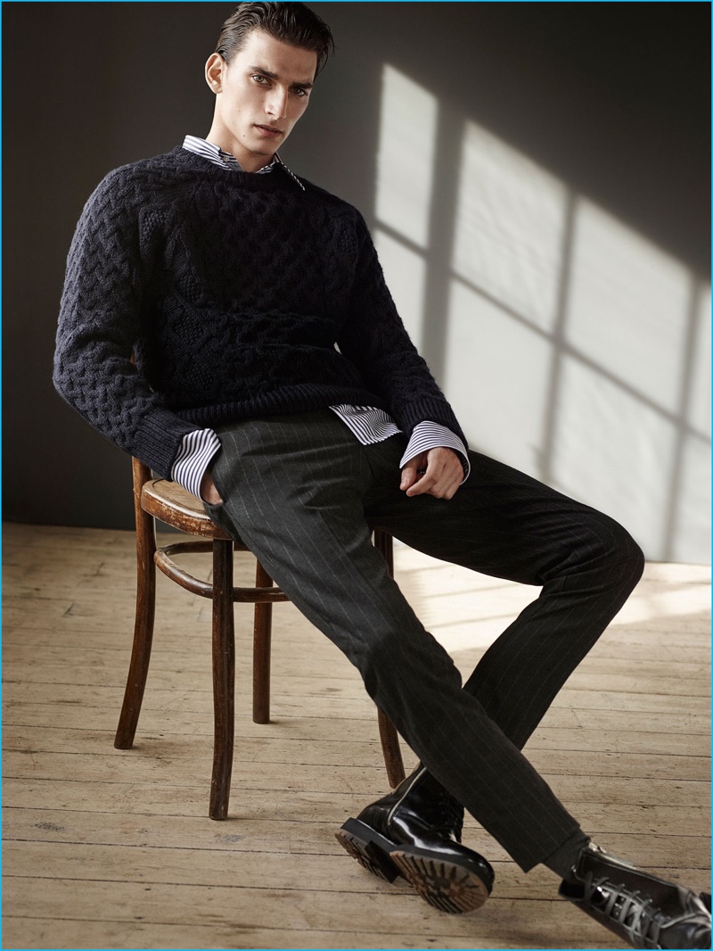 Thibaud Charon embraces a smart look from Zara Man, wearing a fisherman sweater with pinstripe trousers, and black boots.