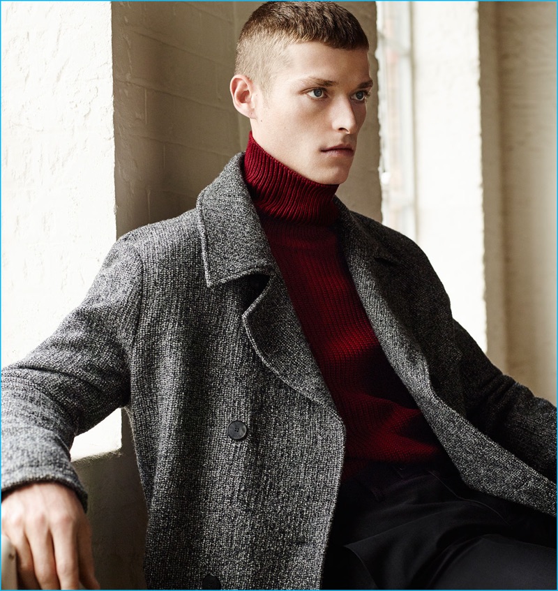 Julius Gerhardt is a chic vision in a Zara Man double-breasted coat with a red turtleneck sweater and trousers.