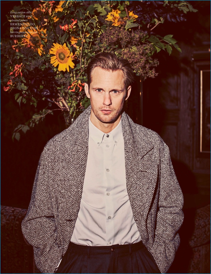 Front and center, Alexander Skarsgård rocks a Versace shirt with Ermenegildo Zegna Couture trousers, and a herringbone coat by Burberry.