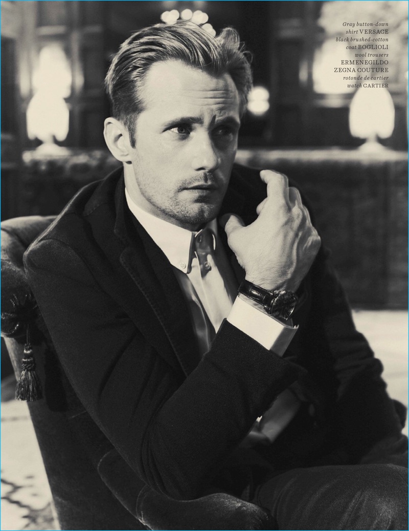 Guy Aroch photographs Alexander Skarsgård in a Versace shirt, Boglioli coat, Cartier watch, and Ermenegildo Zegna Couture wool trousers.