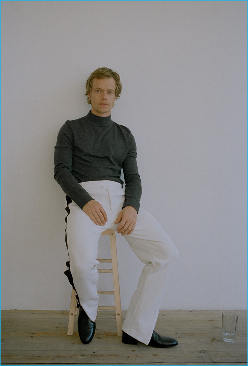Front and center, Alfie Allen dons a Nicole Farhi turtleneck with Joseph track pants and leather Paul Smith boots.
