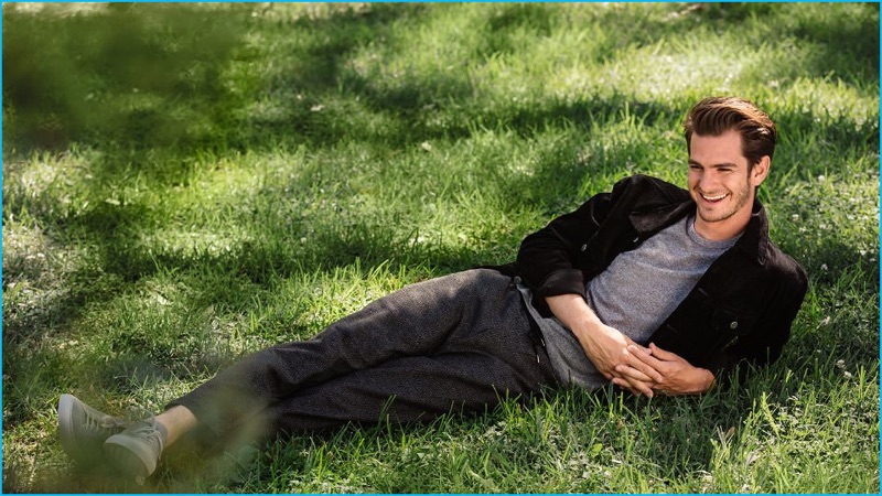 Relaxing outside, Andrew Garfield wears an A.P.C. slim-fit corduroy jacket and Officine Generale mélange t-shirt. Garfield also sports John Elliott tapered trousers with Common Projects sneakers.