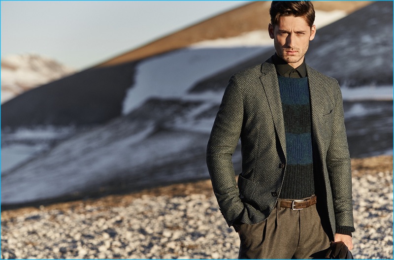 A smart vision, Carlos Ferra sports a striped sweater and sport coat with pleated trousers from Baldessarini. 