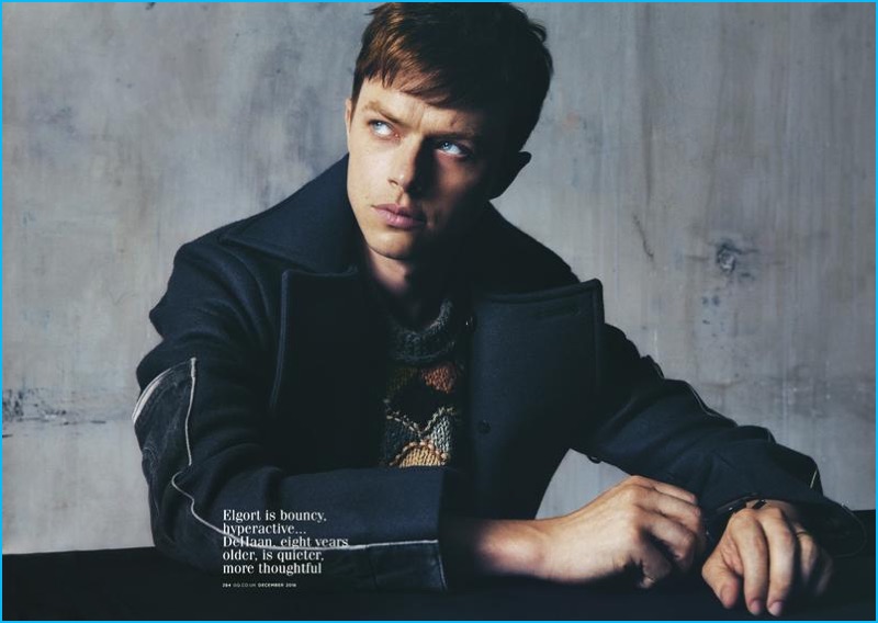 Dane DeHaan sports a tailored coat and intarsia wool sweater from Prada.