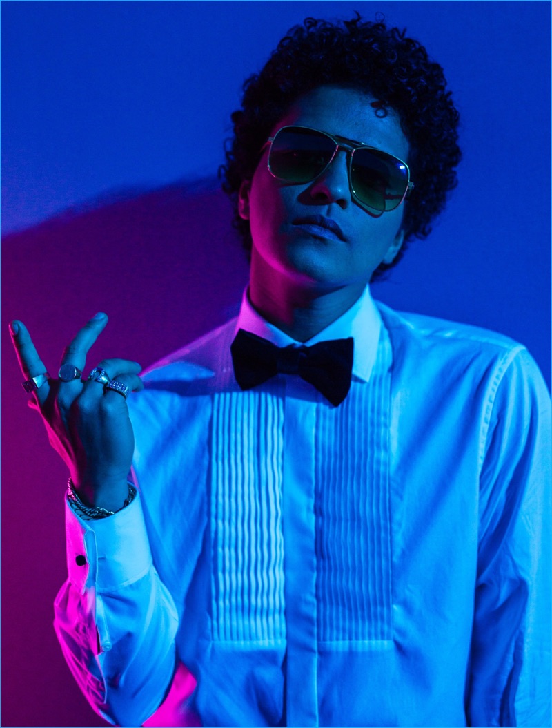 Rocking sunglasses, Bruno Mars sports a tuxedo shirt and bow-tie as he poses behind the scenes of the Victoria's Secret fashion show.